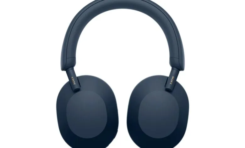 Blue Sony WH-1000XM5 headphones isolated on a white background.
