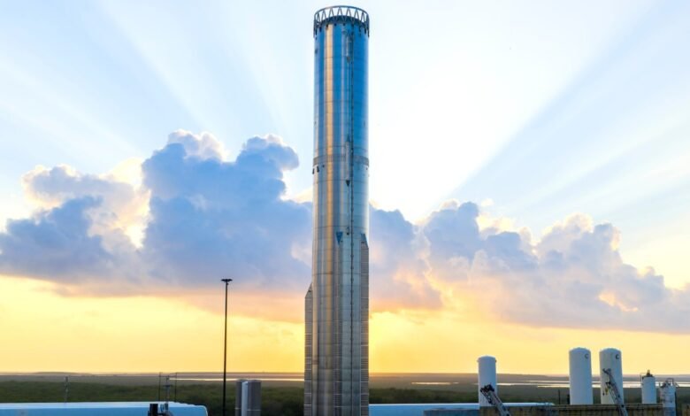 SpaceX Starship stands tall against a vibrant sunset sky.