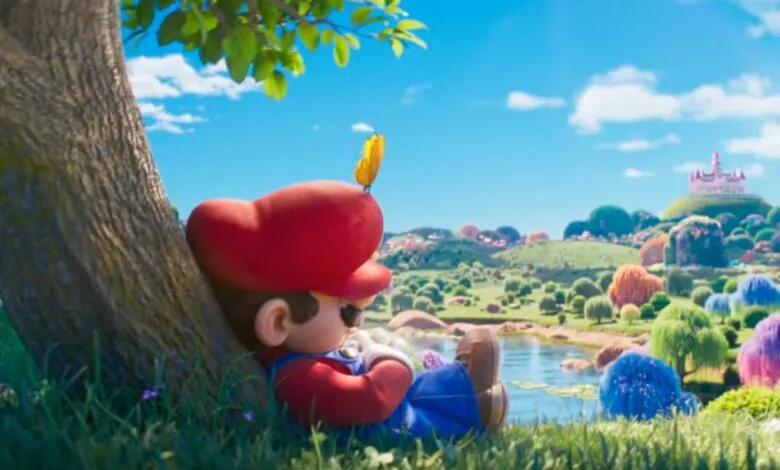 Mario resting against a tree with a butterfly on his hat in a vibrant, colorful landscape.