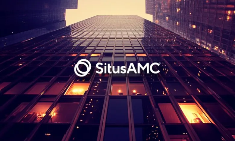 Low angle view of SitusAMC building with warm lighting.