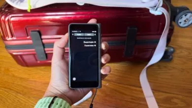 Person holding a portable translator device with English to Italian translation options