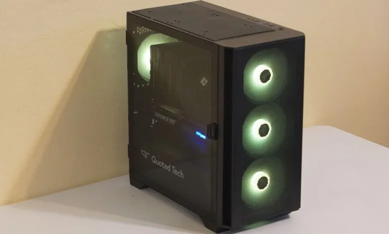 A black computer tower with a glass side panel and illuminated green fans.