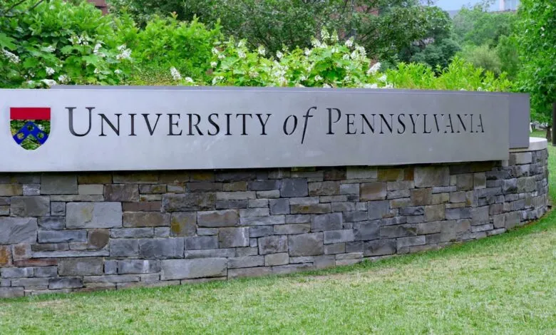 University of Pennsylvania sign with stone base and lush greenery