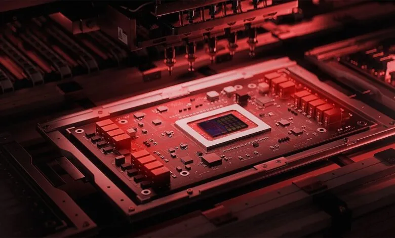 Close-up of a complex computer chip being manufactured under red lighting.