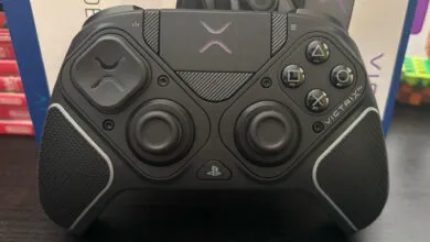 Close-up of a black Victrix Pro gaming controller with illuminated purple accents.