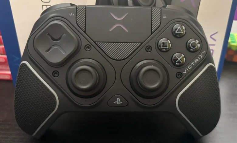Close-up of a black Victrix Pro gaming controller with illuminated purple accents.