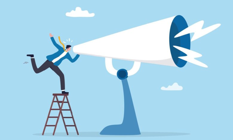 Person on ladder shouting into giant megaphone against blue sky.