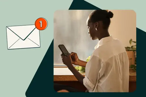 A woman checking her phone with an email notification icon.