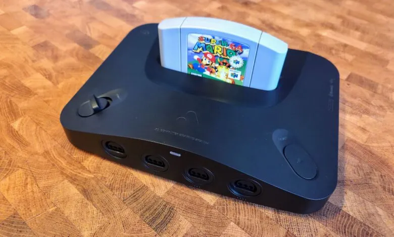 Black Nintendo 64 console with Super Mario 64 game cartridge inserted.