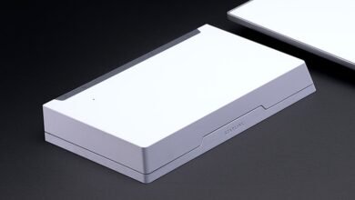 Starlink router on a dark surface, showcasing its minimalist design.