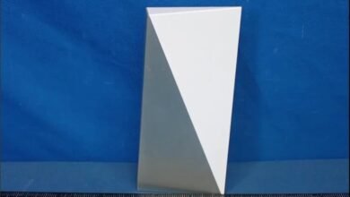 White rectangular prism with triangular facets against a blue background.