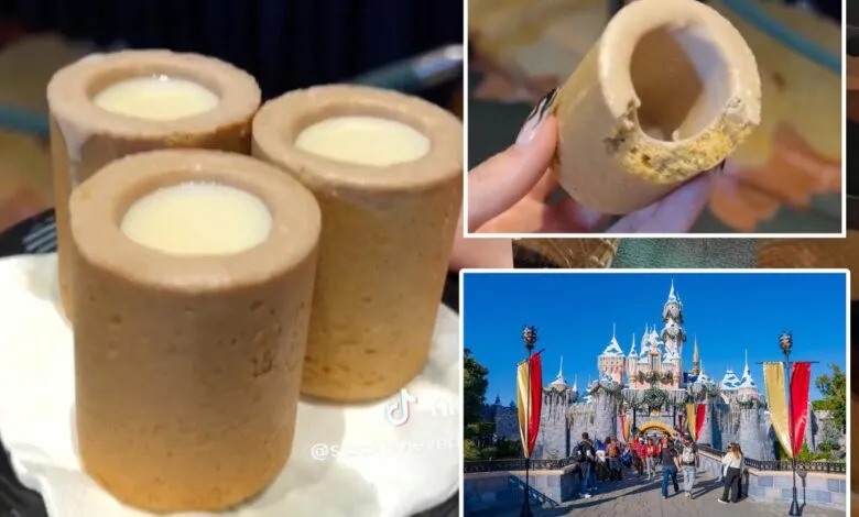 Cookie shot glasses filled with cream, Disneyland castle in background.