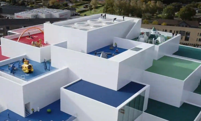 Aerial view of the Lego House in Billund, Denmark, with colorful rooftop playgrounds.