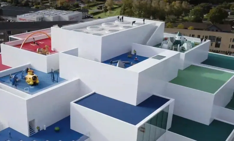 Aerial view of the Lego House in Billund, Denmark, with colorful rooftop playgrounds.