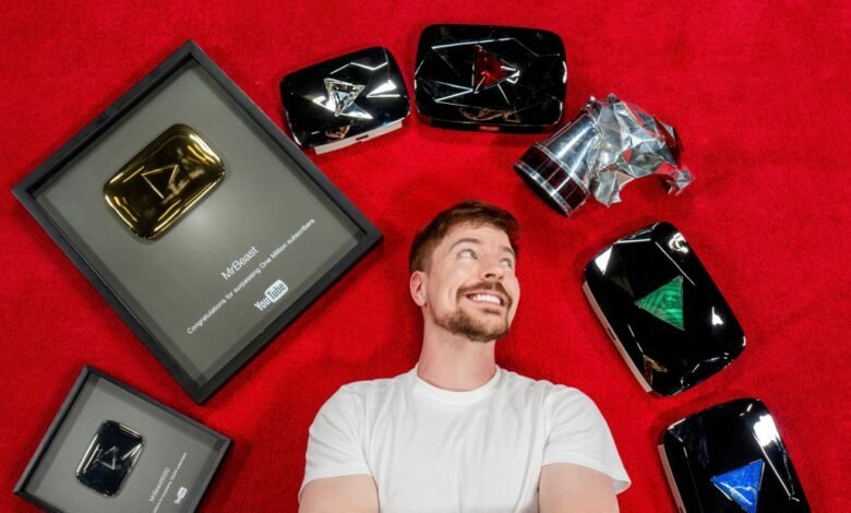 MrBeast lies on red carpet surrounded by YouTube creator awards.