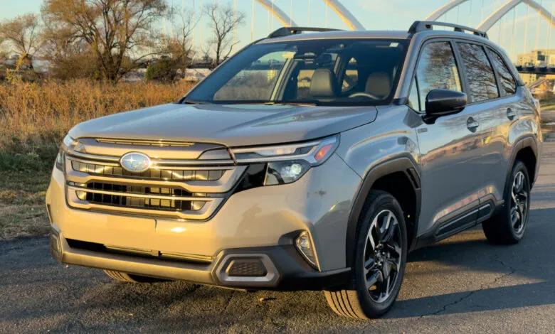 Gray 2025 Subaru Forester Hybrid SUV parked on asphalt road.