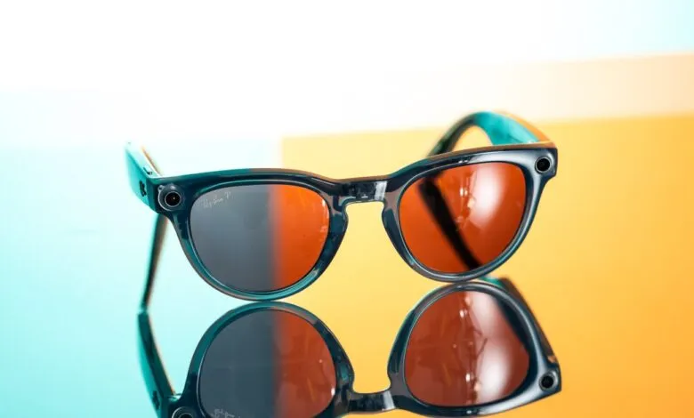 Ray-Ban Meta smart glasses with camera on reflective surface.