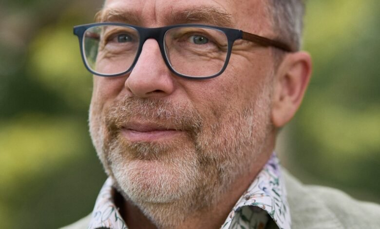 Close-up of Jimmy Wales wearing glasses and a patterned shirt.