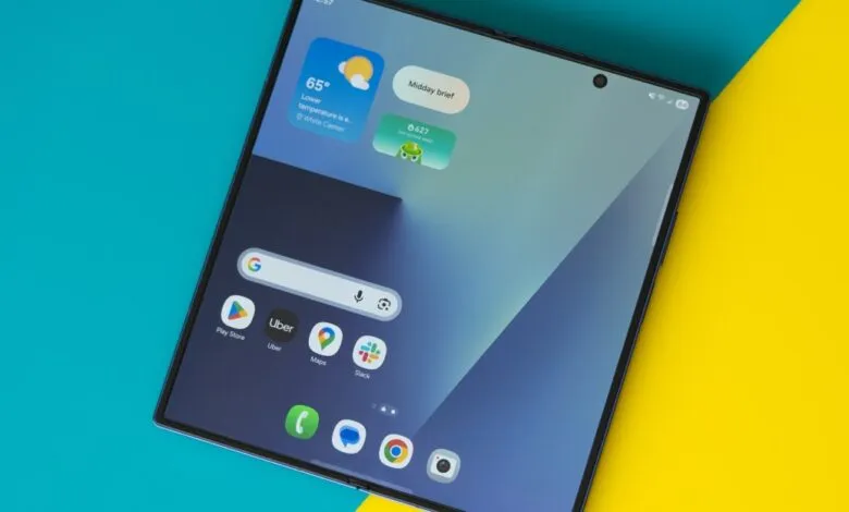 Foldable smartphone displaying home screen with widgets and app icons.