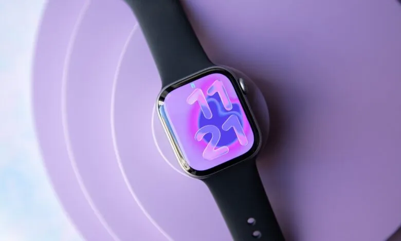 Apple Watch with a purple gradient face displaying '11:21' on a purple background.