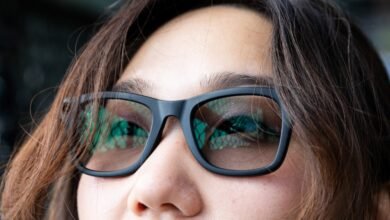 Close-up of a person wearing black Ray-Ban Meta smart glasses.