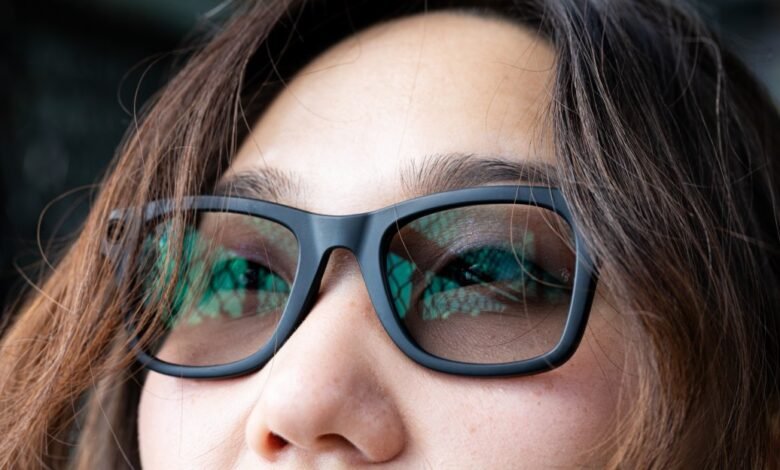 Close-up of a person wearing black Ray-Ban Meta smart glasses.