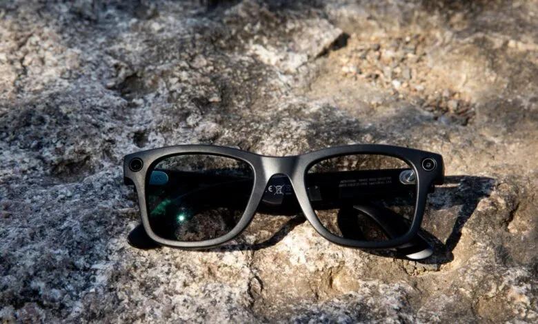 Ray-Ban Meta smart glasses with camera on textured rock surface.