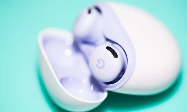 Close-up of Google Pixel Buds A-Series in charging case on a teal background.