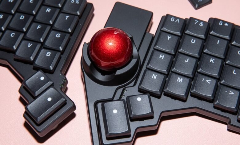 Ergonomic split keyboard with trackball for comfortable typing.
