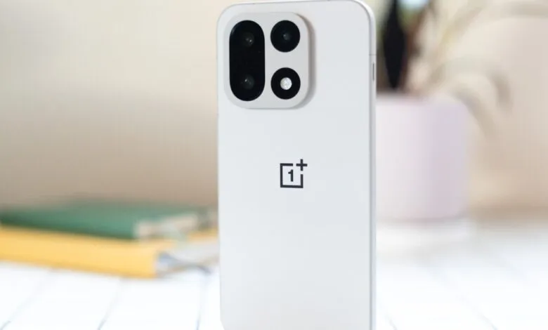 Close-up of a white OnePlus phone showing the camera and logo.