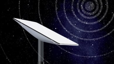 Starlink dish against a starry night sky with spiral galaxy effect.