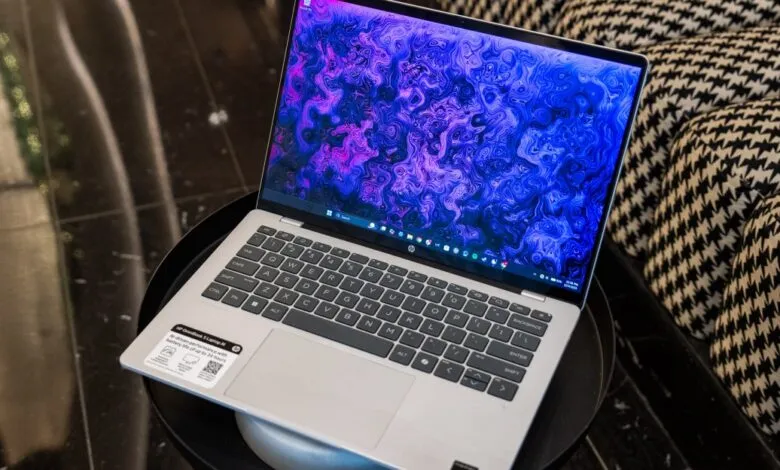 HP OmniBook laptop with a vibrant blue and purple abstract wallpaper.