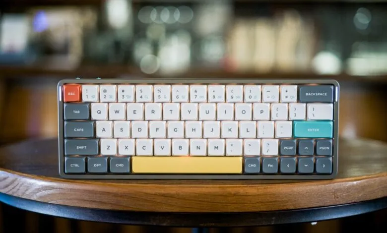 Compact mechanical keyboard with custom keycaps on a wooden table.