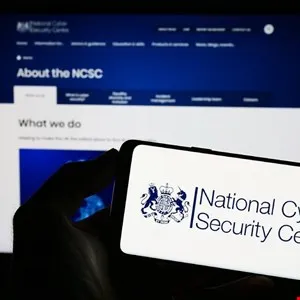 Smartphone displays National Cyber Security Centre logo in front of website.
