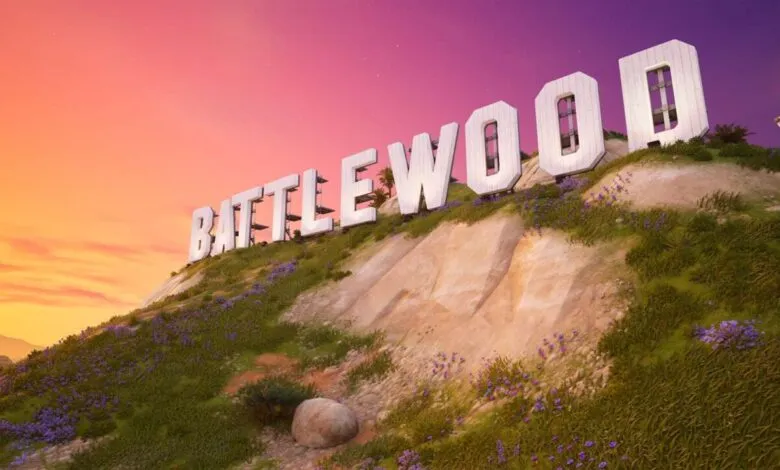 Battlewood sign on a hill against a vibrant sunset sky.