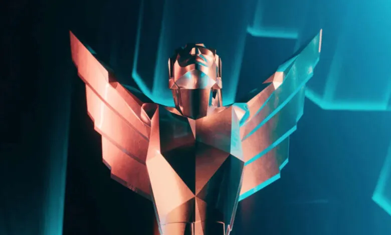 The Game Awards trophy, a winged figure, shines in blue and copper light.