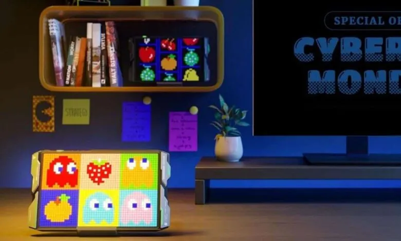 Pixel art display showing Pac-Man characters and fruit, Cyber Monday ad on screen.