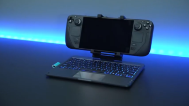 Steam Deck mounted on keyboard with blue backlight, dark background.