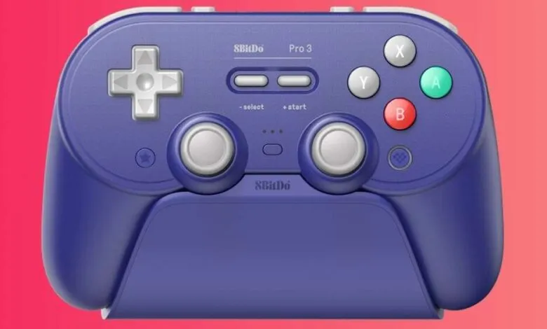 8BitDo Pro 3 controller in purple and white on a stand.