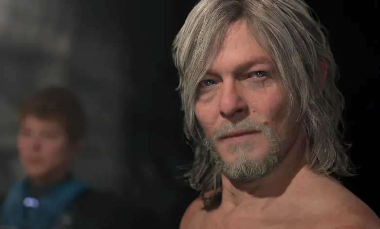 Close-up of Norman Reedus with gray hair and beard, looking directly at the viewer.