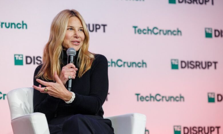 Joanna Coles speaks at TechCrunch Disrupt, holding a microphone.