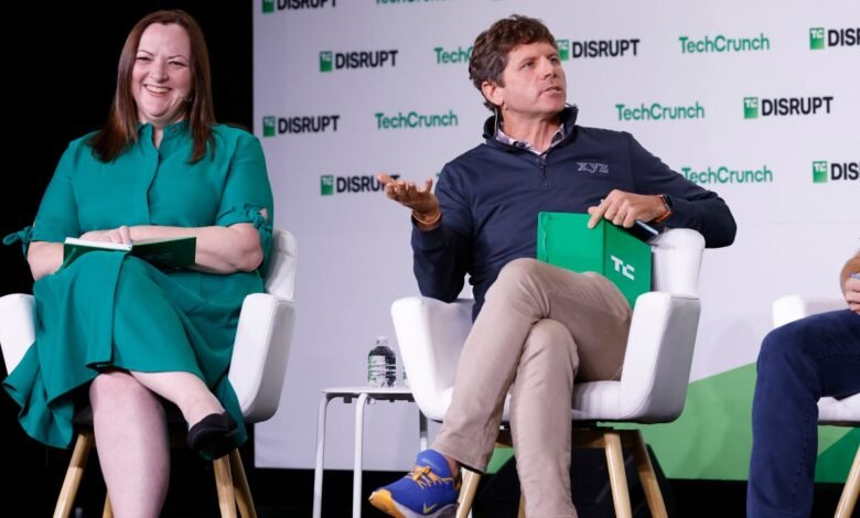 Two speakers sit on stage at TechCrunch Disrupt, one in green dress, one in navy sweater.