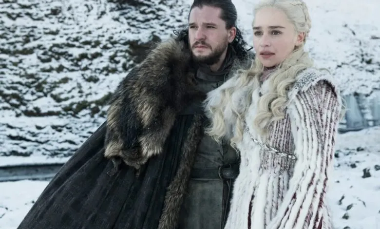 Jon Snow and Daenerys Targaryen stand in a snowy landscape.