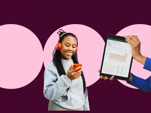 Woman with headphones uses phone while someone holds a tablet showing a graph.