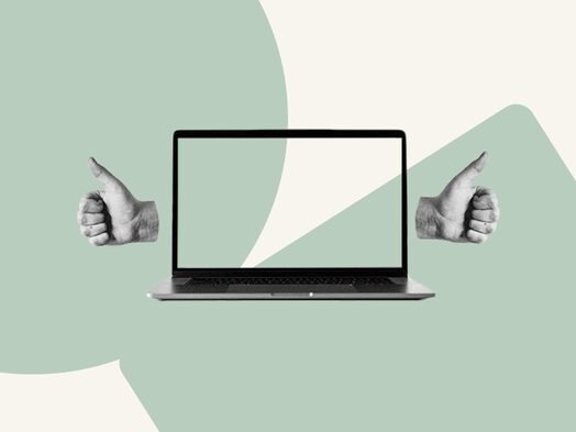 Laptop with thumbs up on a pastel green and beige background.