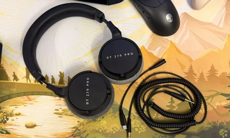 Black Beyerdynamic DT 270 Pro headphones with coiled cable on a scenic mousepad.