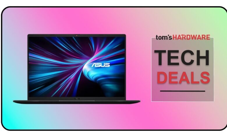 Asus laptop on display with 'Tech Deals' graphic, pink and blue background.
