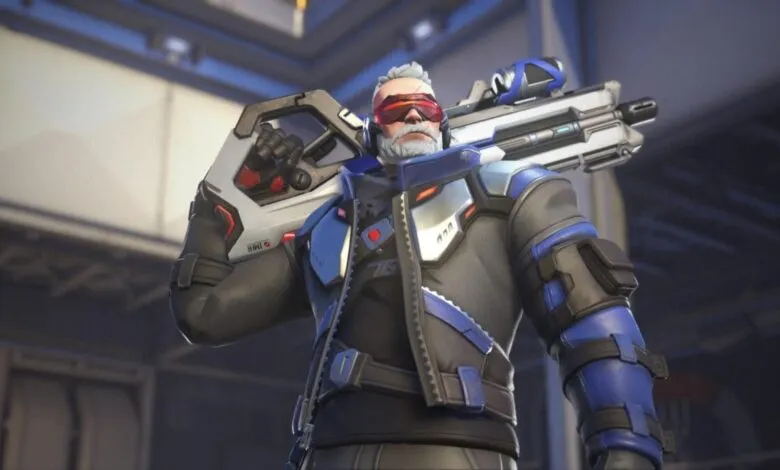 Soldier: 76 from Overwatch, holding a large weapon over his shoulder.