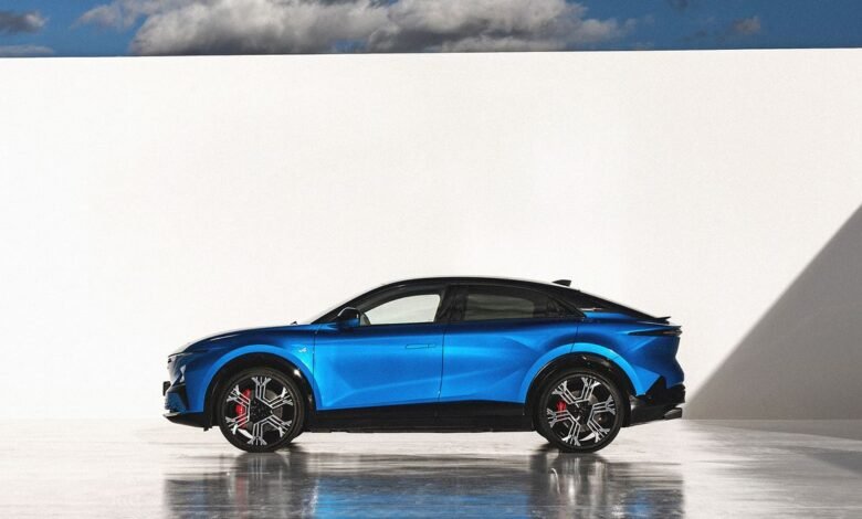 Side view of a blue Alpine A390 GT electric car against a white wall.