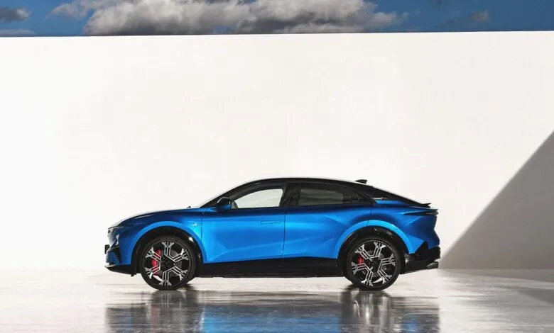 Side view of a blue Alpine A390 GT electric car against a white wall.